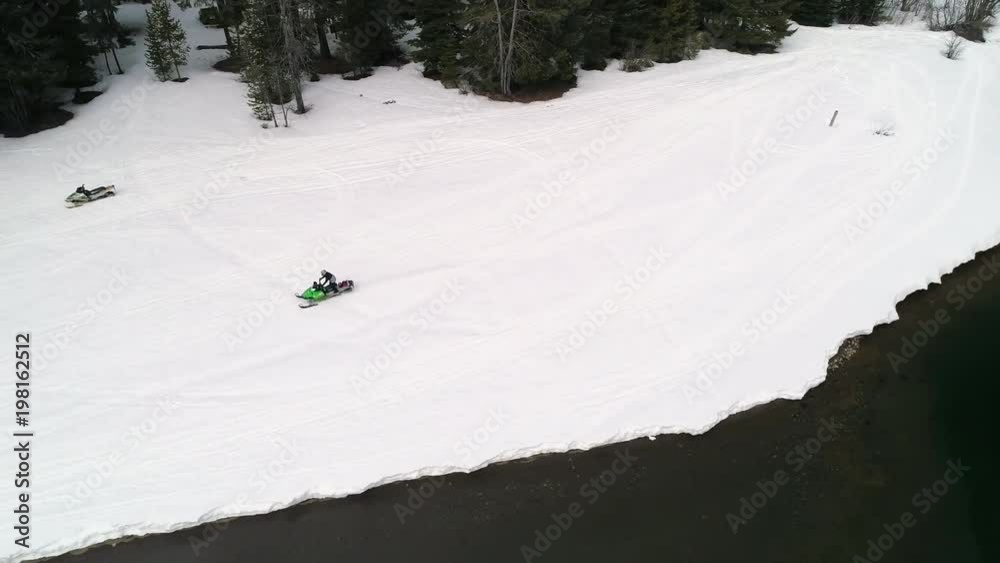 Riding Snowmobile Fast by Sno Park Lake