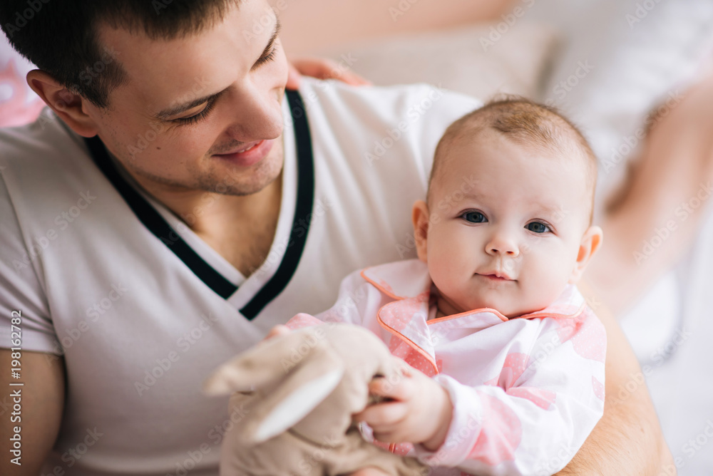 Smiling young father and daugther are very happy, they are at home on the home interior Smiling young father and daugther are very happy, they are at home on the home interior