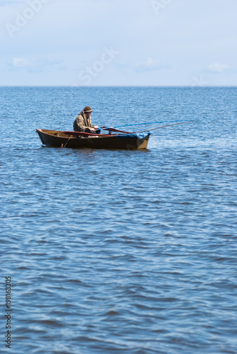 fisher in a boat at Baikal © Alexander