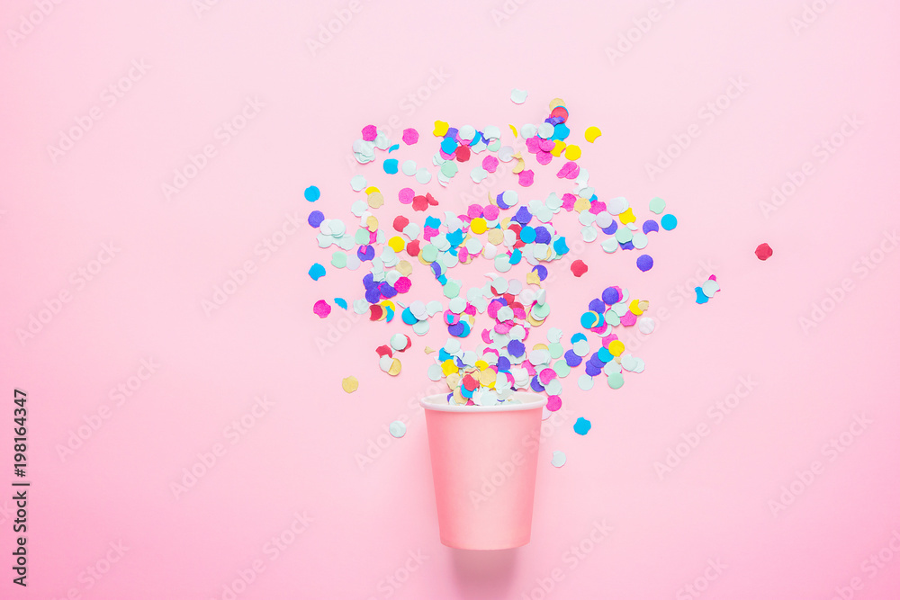 Drinking Paper Cup with Multicolored Confetti Scattered on Fuchsia Background. Flat Lay Composition. Birthday Party Celebration Kids Fun Cheerful Atmosphere. Greeting Card Poster Template. Copy Space Drinking Paper Cup with Multicolored Confetti Scattered on Fuchsia Background. Flat Lay Composition. Birthday Party Celebration Kids Fun Cheerful Atmosphere. Greeting Card Poster Template. Copy Space