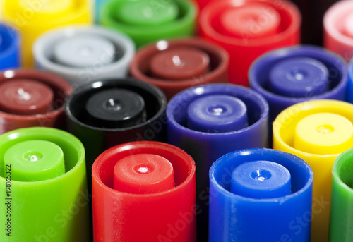 Colourful pen top lids closeup with a shallow depth of field.