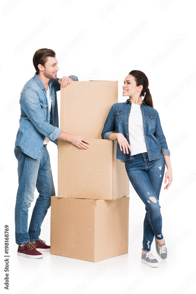 young moving couple with cardboard boxes, isolated on white young moving couple with cardboard boxes, isolated on white