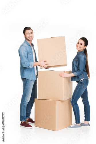 happy young couple moving with cardboard boxes, isolated on white