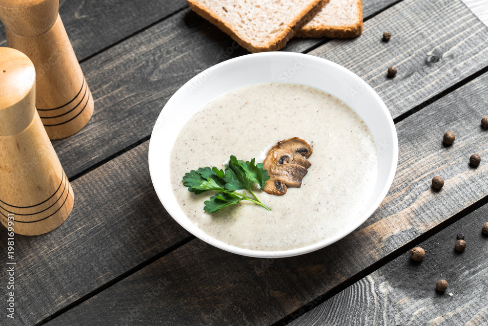 A bowl of mushroom soup cream on the table A bowl of mushroom soup cream on the table