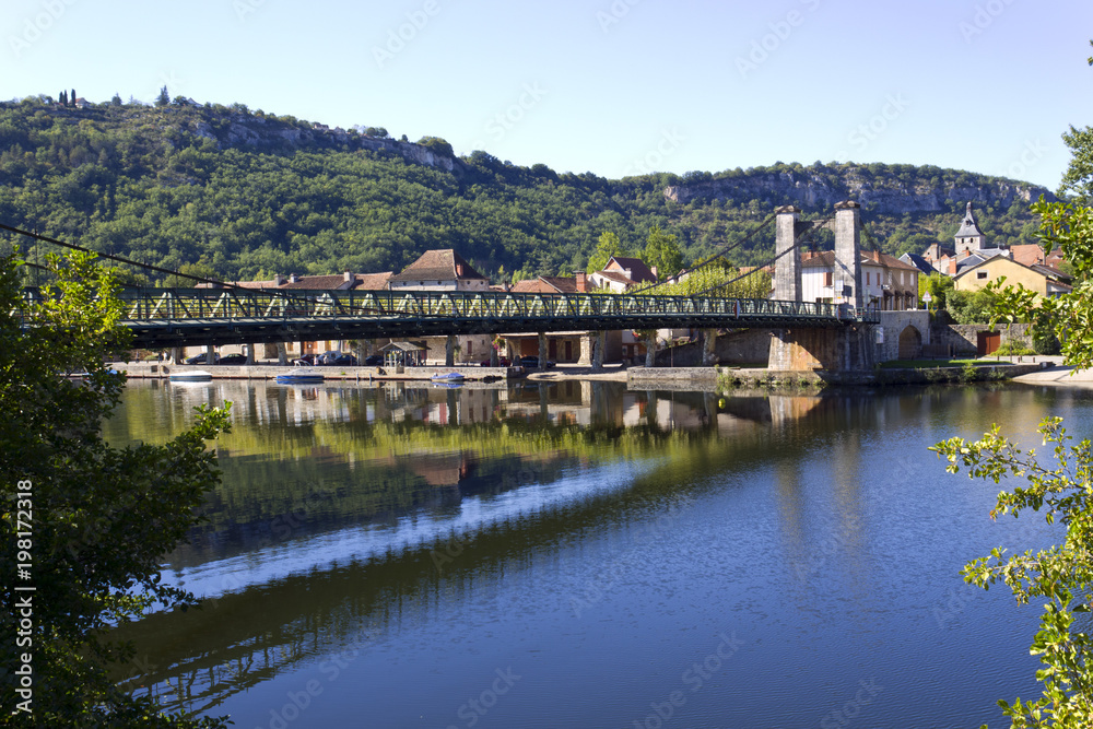 The River Lot and suspension bridge at picturesque Cajarc in the Lot Valley, Lot, Quercy, France, Europe