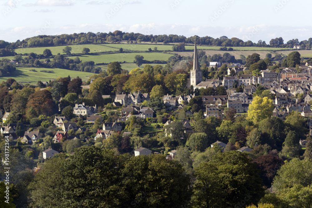 First signs of Autumn colour in the trees around the picturesque Cotswold village of Painswick, Gloucestershire, UK