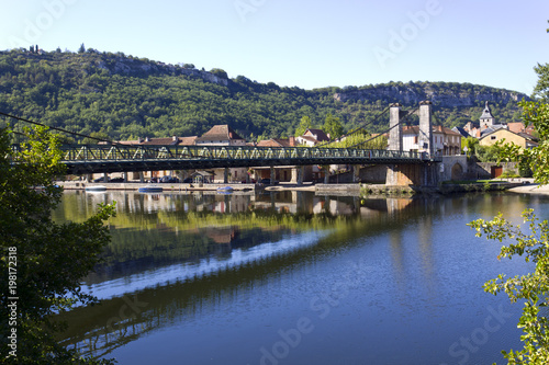 The River Lot and suspension bridge at picturesque Cajarc in the Lot Valley, Lot, Quercy, France, Europe