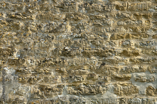 Old lichen covered limestone wall background texture