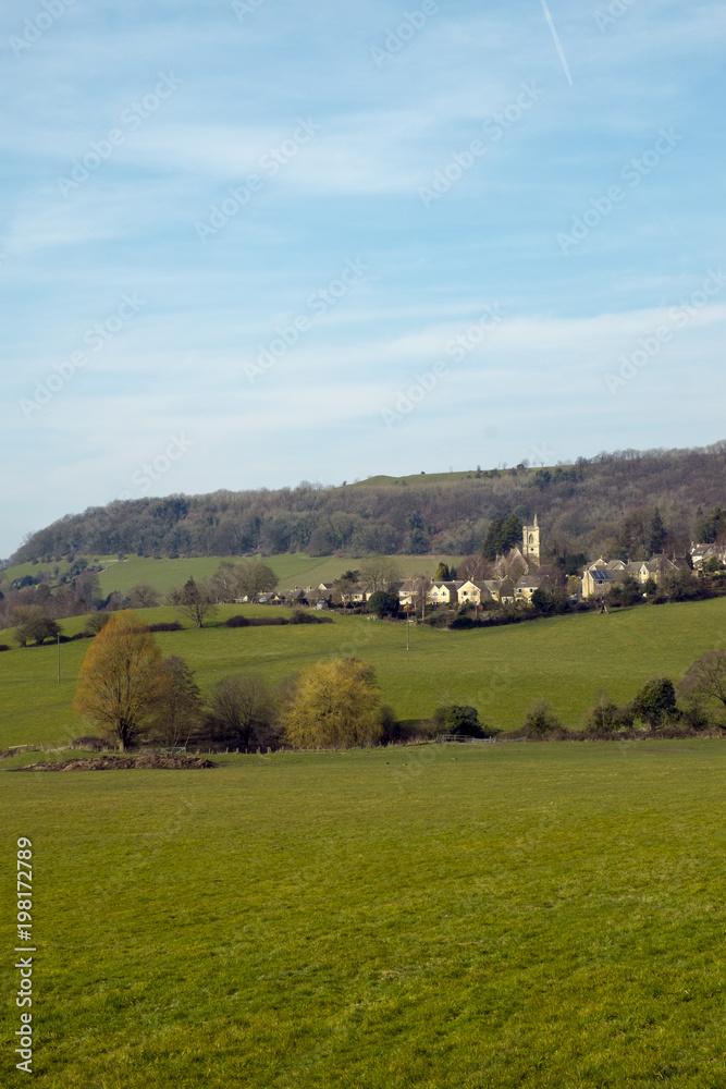 Picturesque Uley village on the edge of the Cotswold Hills escarpment in spring sunshine, Gloucestershire, UK.