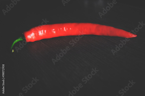  chili pepper on a dark table, top view