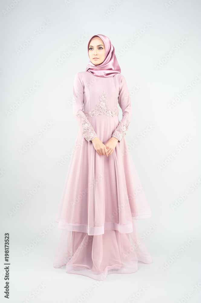Beautiful muslim girl wearing pink asian dress known as Baju Kurung with Hijab.Hijab fashion for Eid Mubarak.Studio Shoot. Beautiful muslim girl wearing pink asian dress known as Baju Kurung with Hijab.Hijab fashion for Eid Mubarak.Studio Shoot.