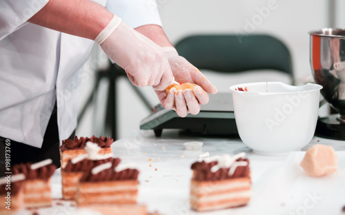 Confectioner preparing cake in pastry shop, confectionery