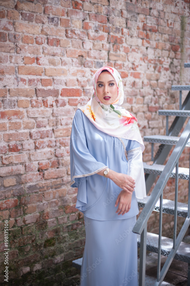 Hijab fashion portraiture.Beautiful muslim girl wearing traditional dress with hijab,outdoor shoot.