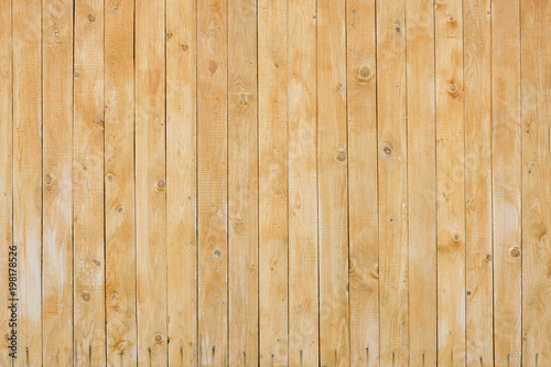 Fence made of fresh yellow planks.