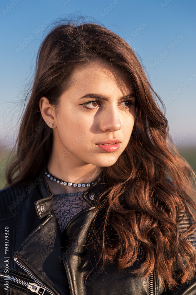Portrait of beautiful young woman dressed with a black leather jacket Portrait of beautiful young woman dressed with a black leather jacket