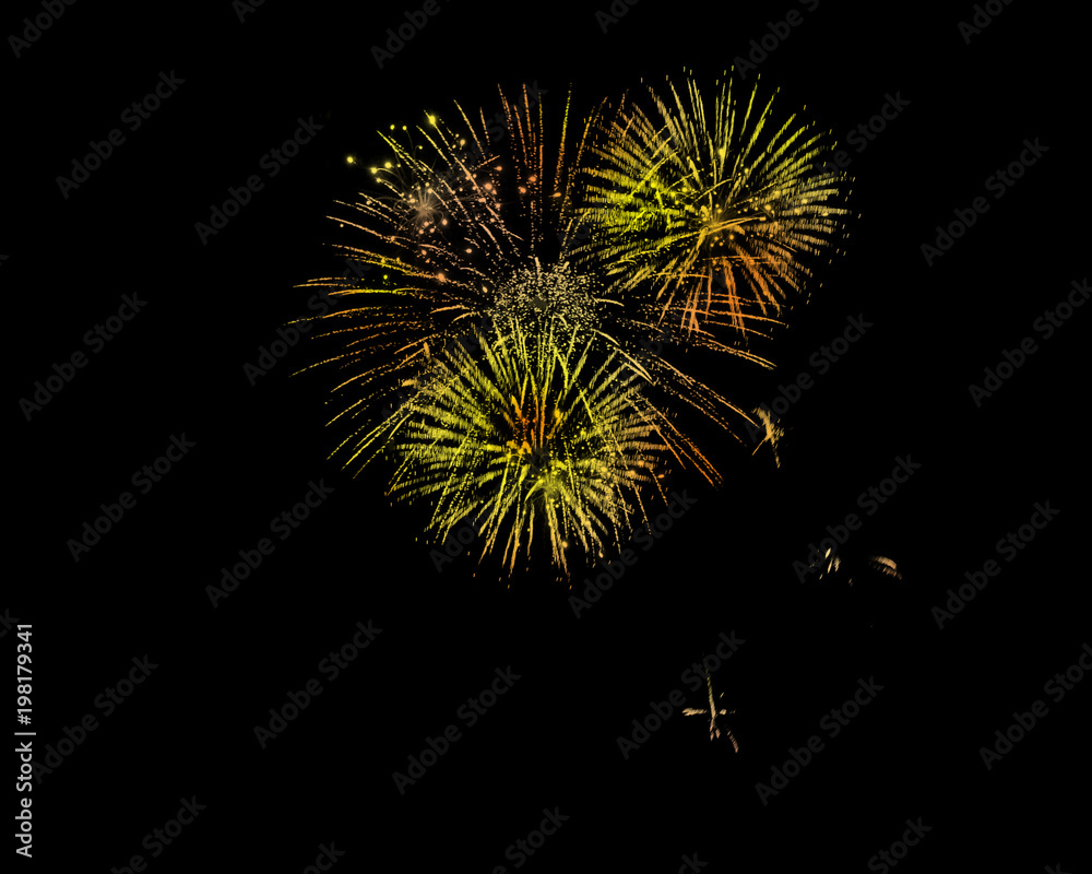 Celebration fireworks at night sky with yellow orange colours.