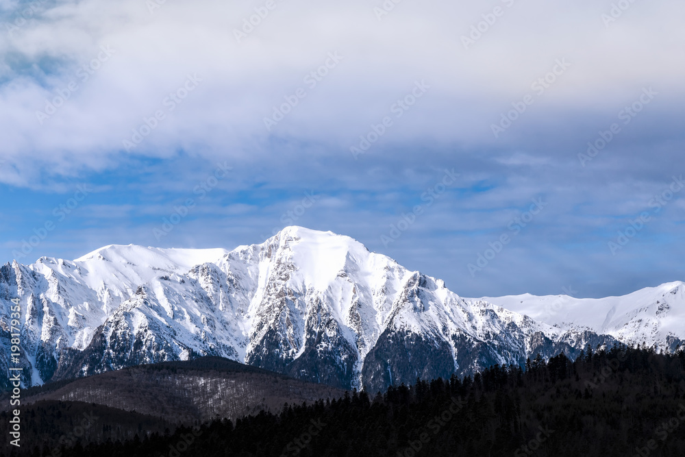 Snow peaks in the cloudy day