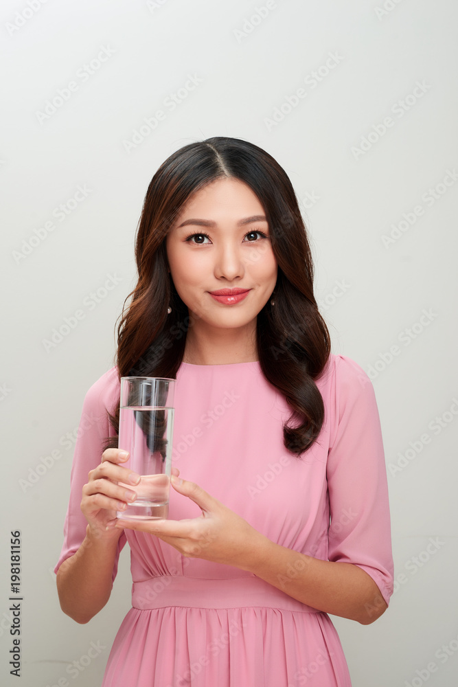 Young asian beautiful woman showing the glass of water. Young asian beautiful woman showing the glass of water.