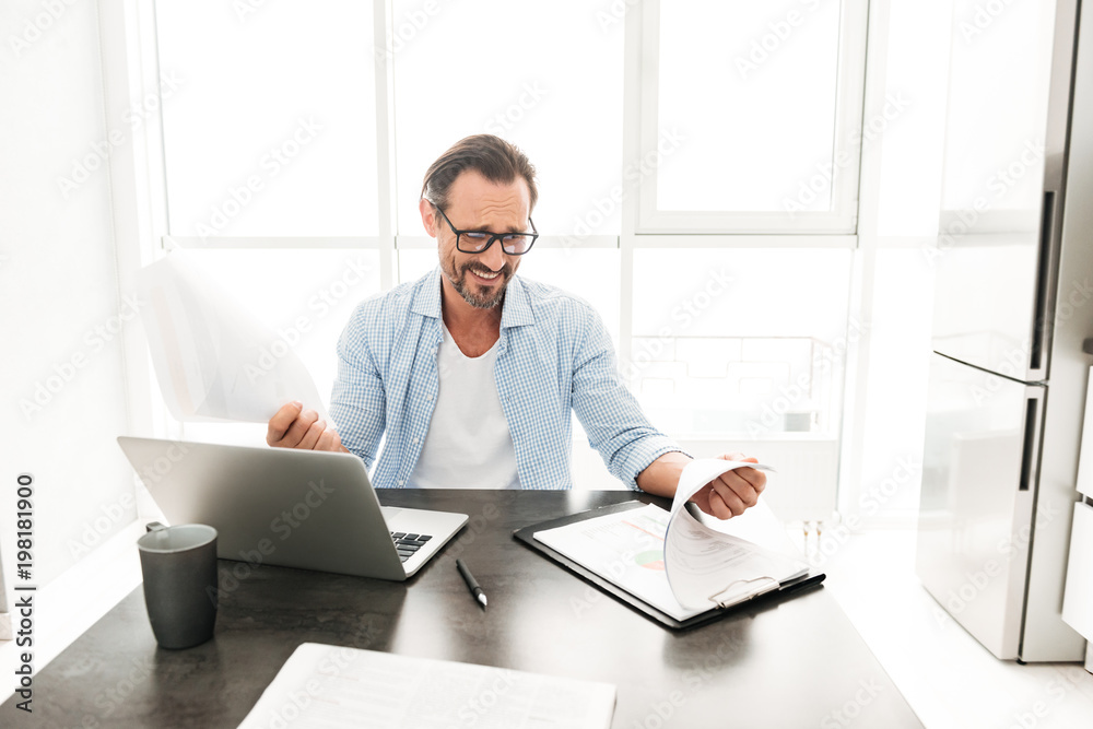 Handsome mature man working with documents