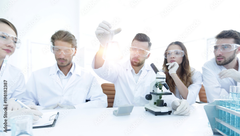 Team of scientists working together at the laboratory Team of scientists working together at the laboratory