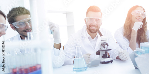 background image is a group of scientists microbiologists.