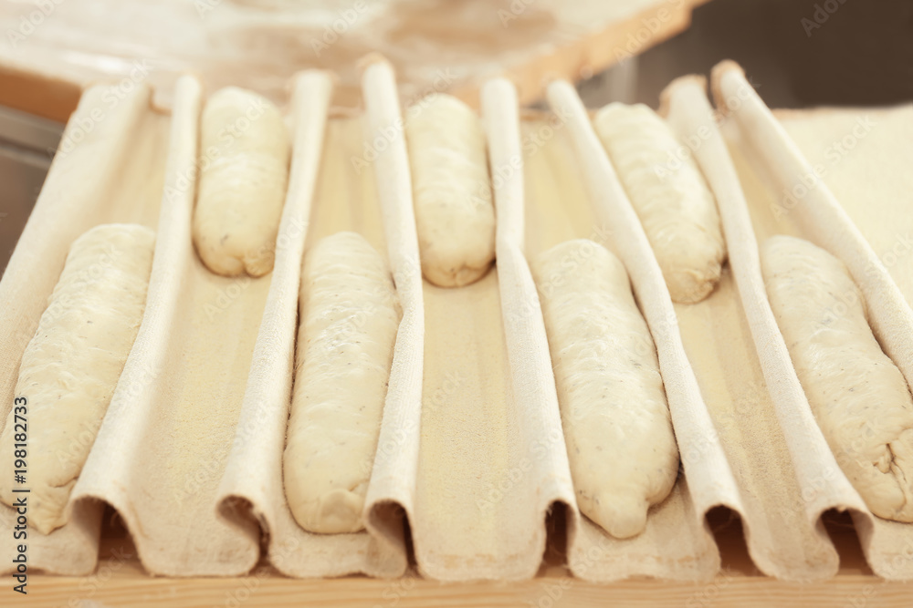 Fototapeta premium Raw fresh bread on table in bakery