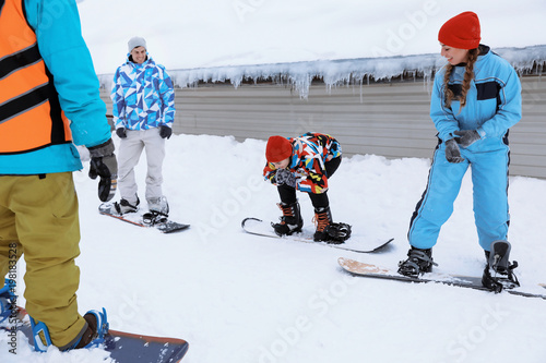 Young woman taking snowboar...