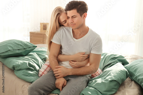 Young lovely couple on bed ...
