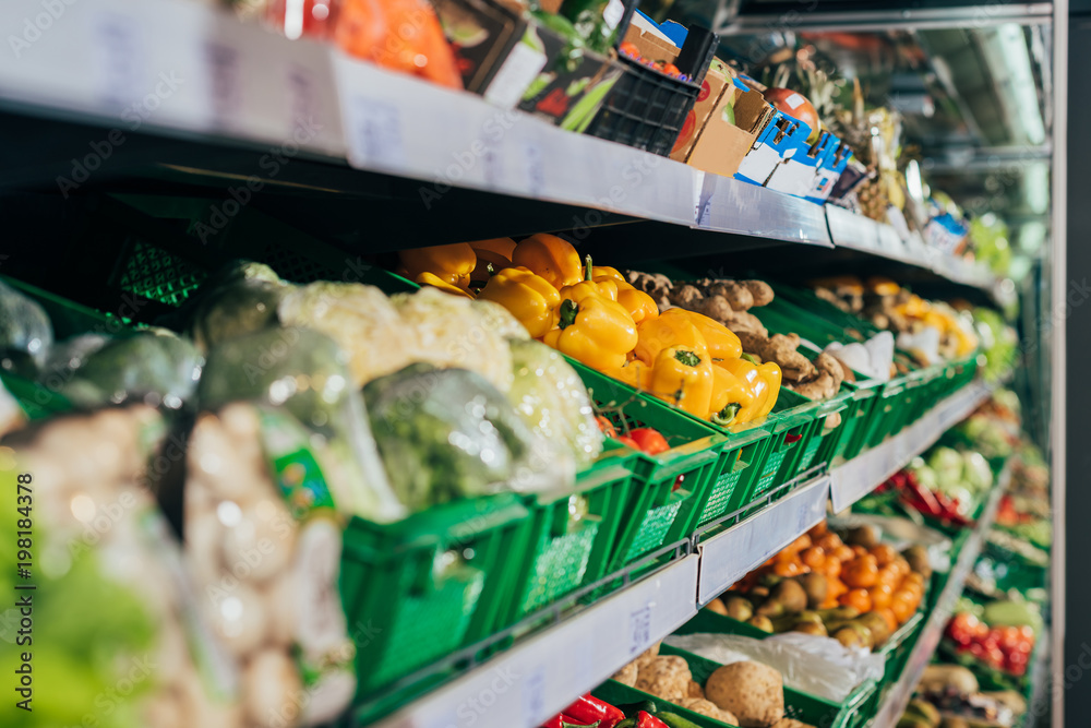 Fototapeta premium close up view of arranged fresh vegetables in grocery shop