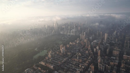 New York City aerial view of Manhattan from the Upper West Side and Central Park at sunrise, with fog and low level clouds over Midtown.