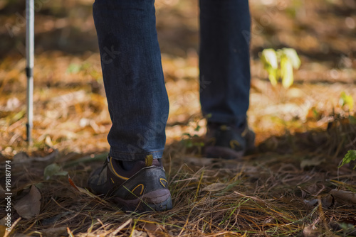 foot of young Man Traveler with backpack relaxing outdoor with rocky mountains on background Summer vacations and Lifestyle hiking concept. © EKKAPON