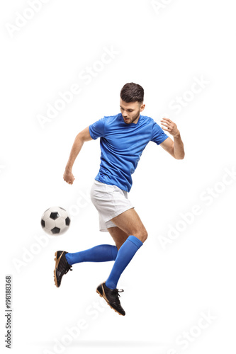 Fototapeta Naklejka Na Ścianę i Meble -  Soccer player doing a trick with a football