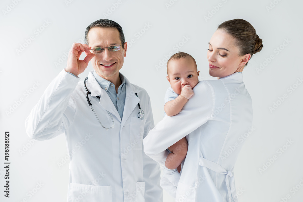 pediatricians with little baby isolated on white