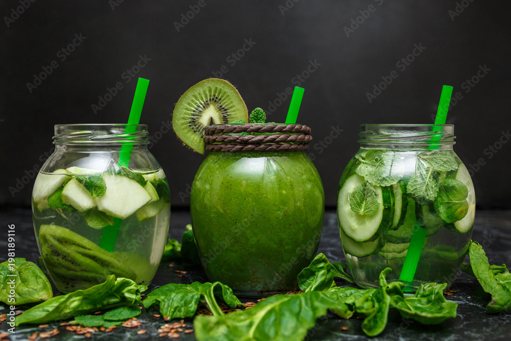 Blended green smoothie and detox with ingredients on table Blended green smoothie and detox with ingredients on table