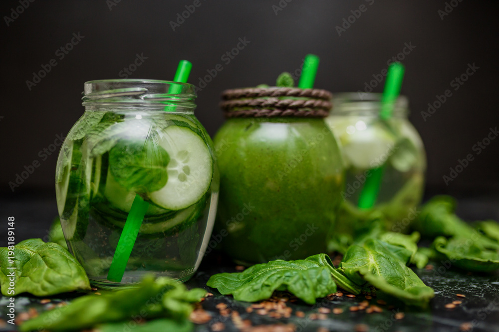 Blended green smoothie and detox with ingredients on table Blended green smoothie and detox with ingredients on table