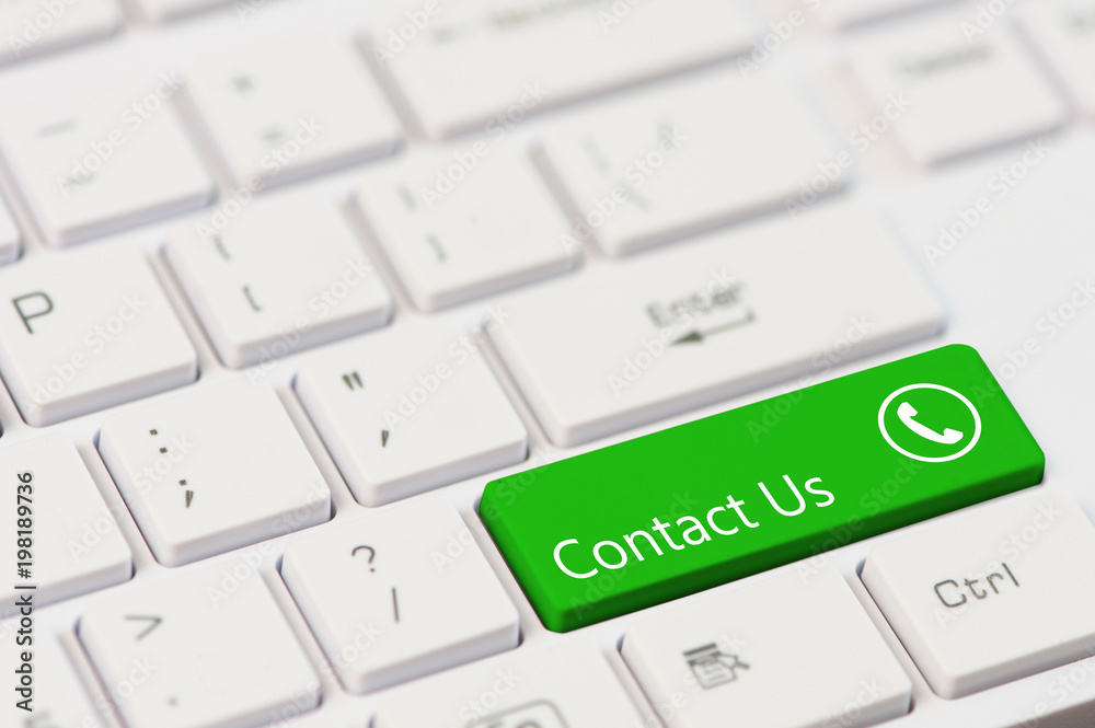 green key with text Contact us and open phone icon on white laptop keyboard green key with text Contact us and open phone icon on white laptop keyboard