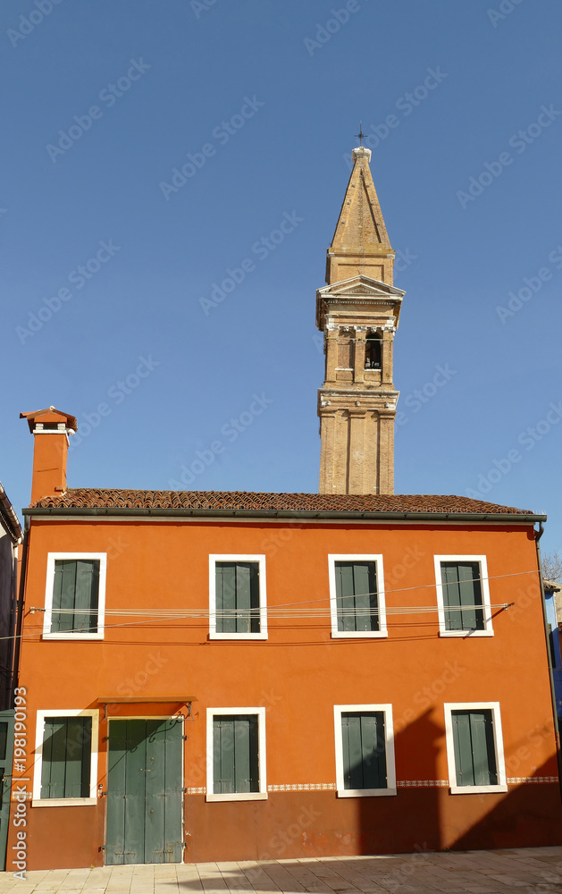 Italy, Venice, Burano island, colorful house with the leaning campanile of San Martino Italy, Venice, Burano island, colorful house with the leaning campanile of San Martino