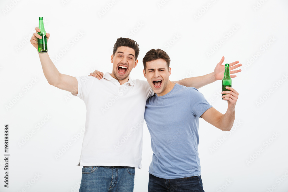 Portrait of two joyful young men celebrating