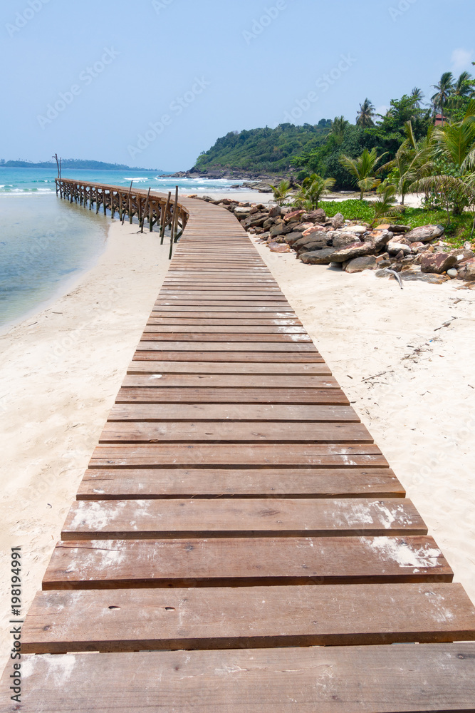 Wooden bridge, corridor to the sea on Beautiful crystal clear sea and tropical beach at tropical paradise island, Thailand