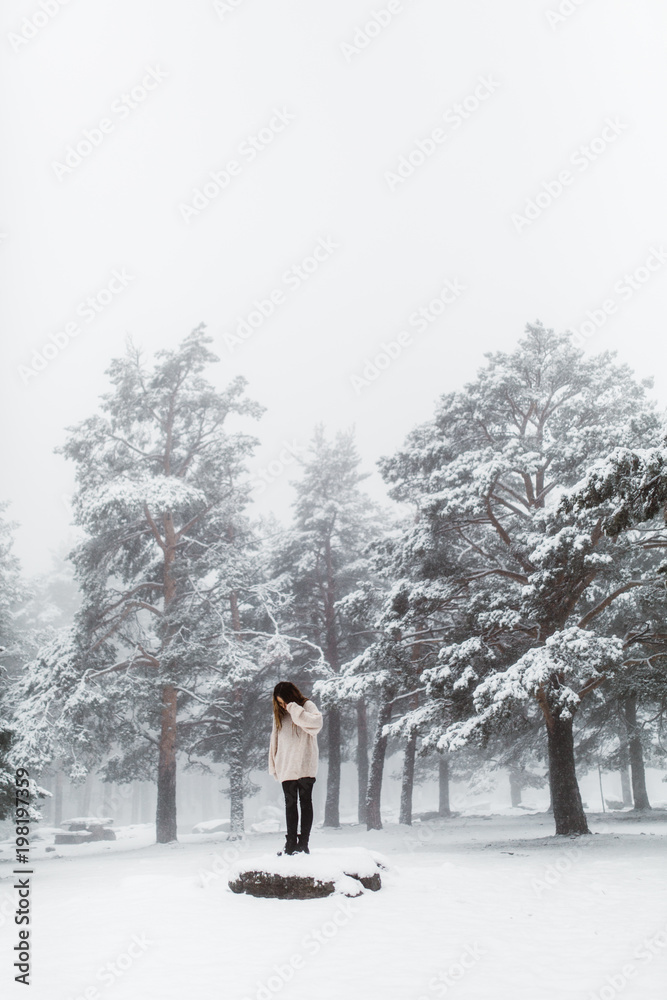 Woman standing on the snow in winter Woman standing on the snow in winter