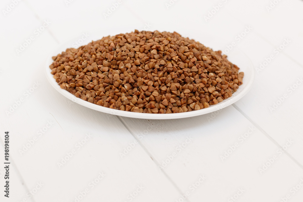 plate of buckwheat isolated on white background. Top view. plate of buckwheat isolated on white background. Top view.