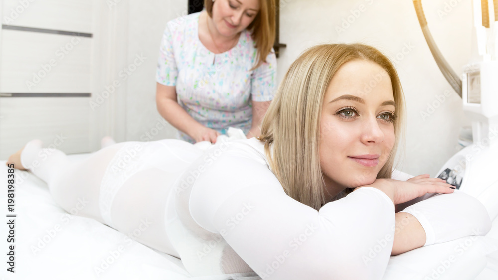 Reset body weight with LPG massage. The blonde girl, in order to care for her figure, attends an LPG massage session in a beauty salon. Reset body weight with LPG massage. The blonde girl, in order to care for her figure, attends an LPG massage session in a beauty salon.
