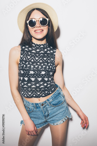 Thoughtful summer woman in hat and sunglasses isolated over a white background © dianagrytsku