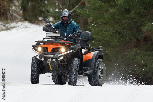 Man driving a quad bike in the winter