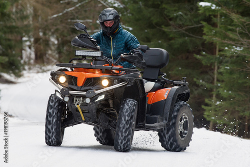Man driving a quad bike in the winter
