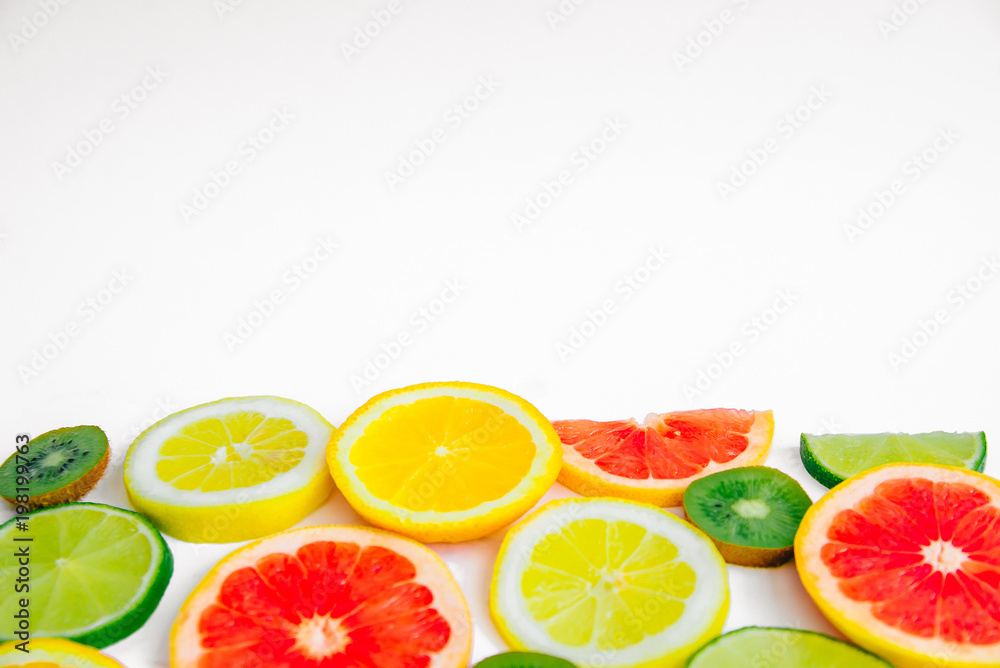 Summer fruit background with lime, lemon, orange, kiwi and grapefruit with space for text Summer fruit background with lime, lemon, orange, kiwi and grapefruit with space for text
