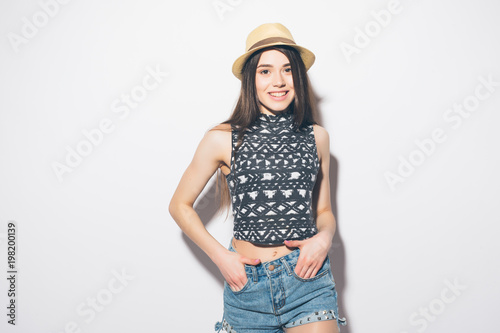 Beauty woman in summer hat isolated on gray background