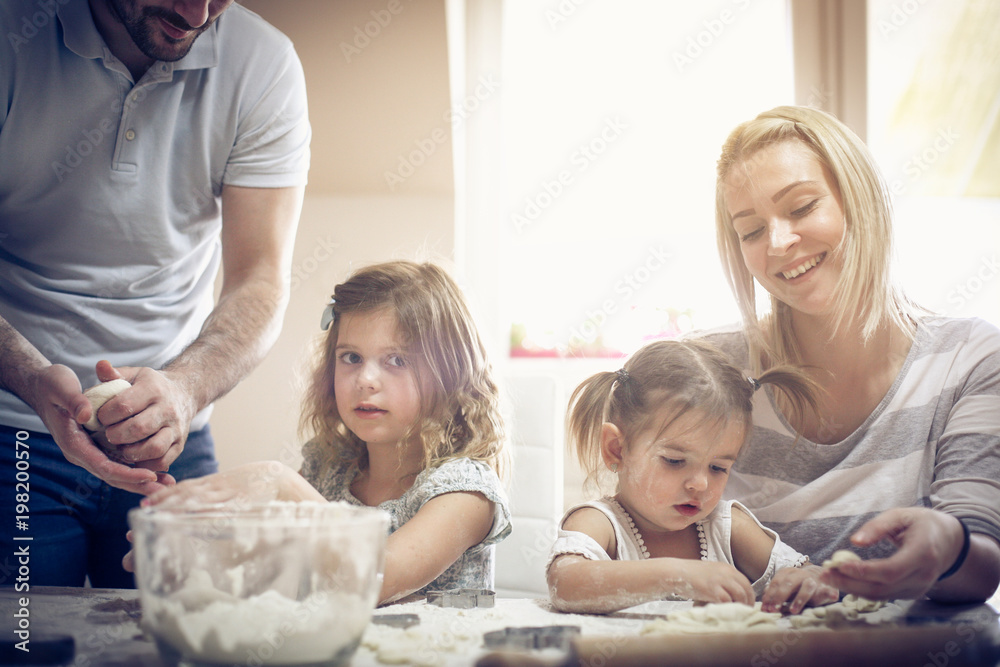 Smiling family in kitchen.