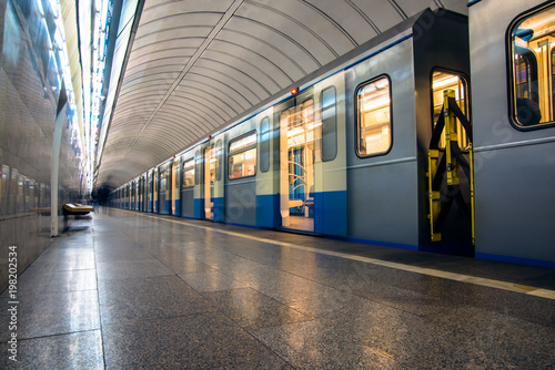 Subway train in motion arriving at station