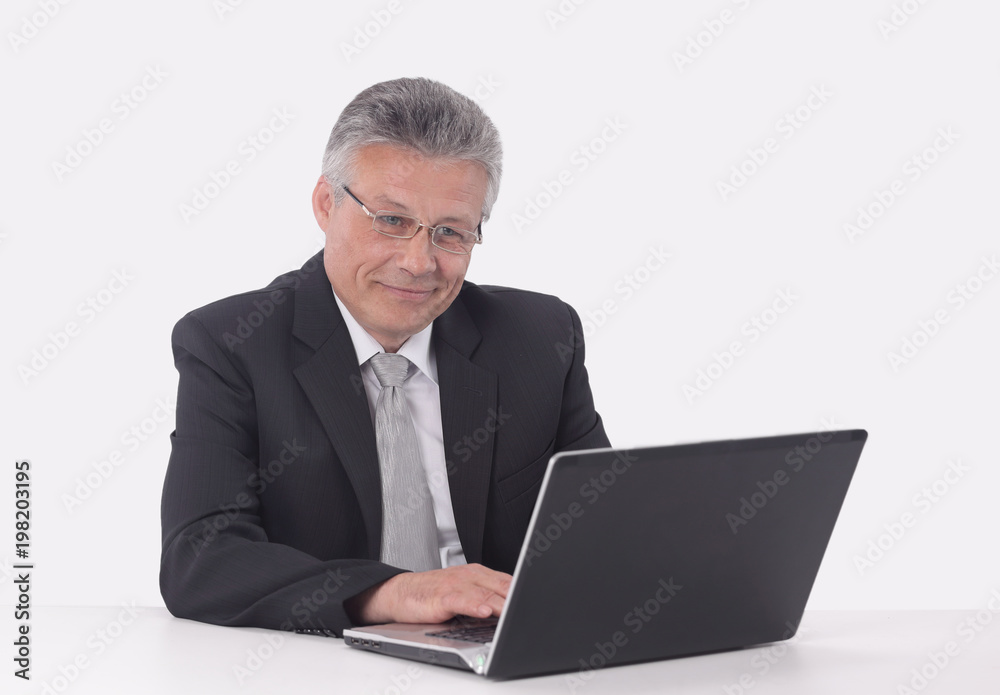 elderly businessman working on a laptop. elderly businessman working on a laptop.